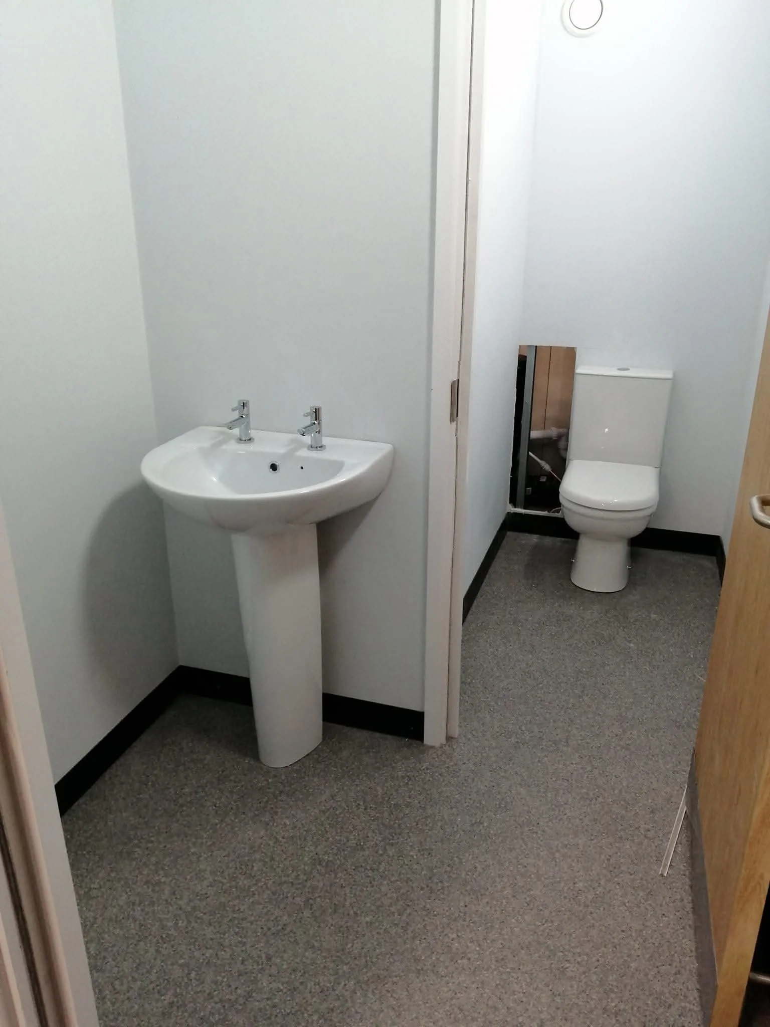 Bathroom before renovation with pedestal sink and toilet