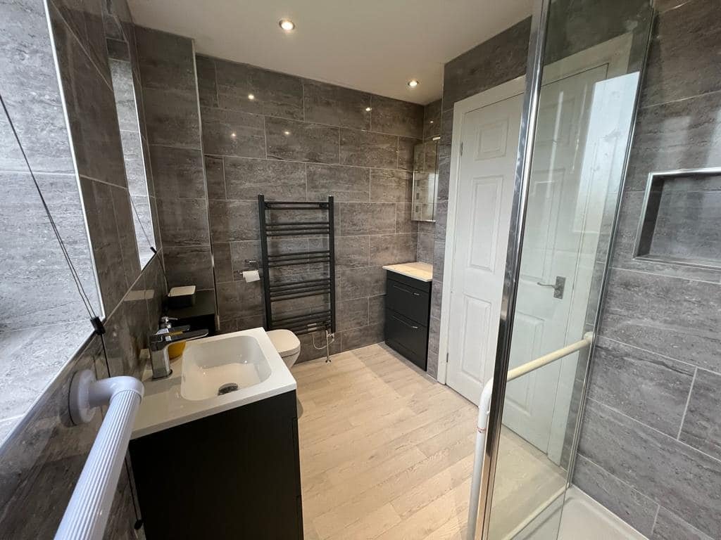 Finished bathroom refit with vanity, toilet and glass shower enclosure